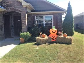 Helena-West Helena apartment for rent - a house with pumpkins on hay bales in a yard