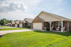 Fort Smith apartment for rent - a row of houses with lawns and chairs in front of them