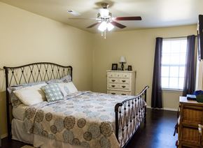 Durant apartment for rent - a bedroom with a bed and a ceiling fan