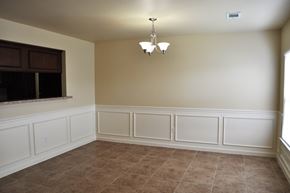 Morrilton apartment for rent - a dining room with white wainscoting and a window