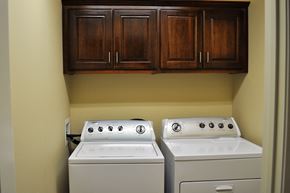 Morrilton apartment for rent - a laundry room with two washer and dryers and cabinets