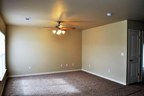 Morrilton apartment for rent - a empty room with a ceiling fan and a door