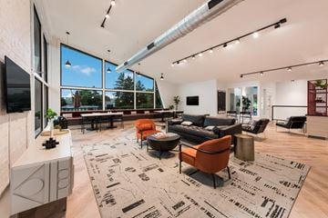Columbus apartment for rent - A modern living room with a large rug and a flat screen TV.