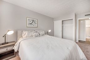 Columbus apartment for rent - A bedroom with a large bed and a painting on the wall.