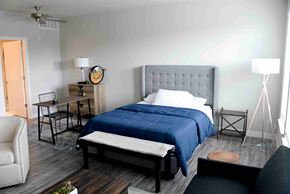 Indianapolis apartment for rent - A bedroom with a bed, chair, and table.