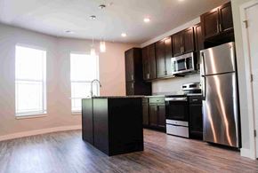 Indianapolis apartment for rent - A kitchen with a black island and stainless steel appliances.