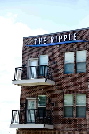 Indianapolis apartment for rent - A brick building with a balcony and a sign that says "The Ripple".