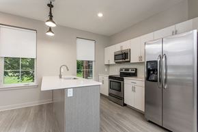 Rochester apartment for rent - a kitchen with stainless steel appliances and a counter top