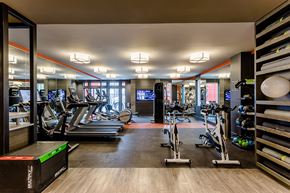 Rochester apartment for rent - a gym with treadmills and other exercise equipment in a room with glass doors