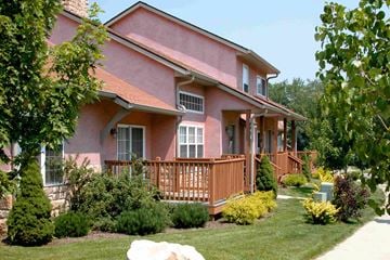 Bloomington apartment for rent - a pink house with a wooden deck in front of it