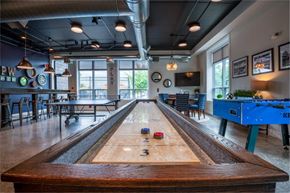Pittsburgh apartment for rent - a shuffleboard table in a game room with a blue pool table