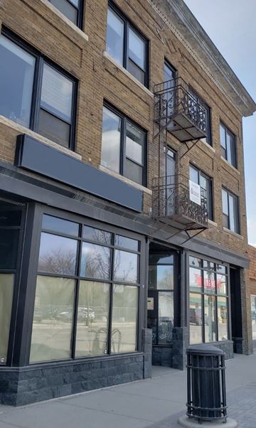 Saskatoon apartment for rent - a brick building with windows and a balcony