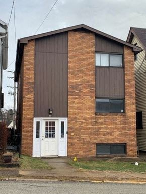 East Mckeesport apartment for rent - a small brick house with a white door
