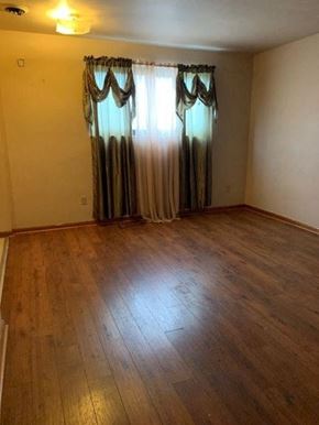 East Mckeesport apartment for rent - an empty living room with curtains and a wooden floor