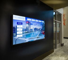 Houston apartment for rent - A large screen displays the name "SKYHOUSE" and images of a building and a pool.