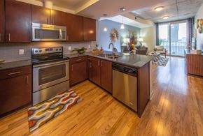Houston apartment for rent - A modern kitchen with wooden cabinets and stainless steel appliances.