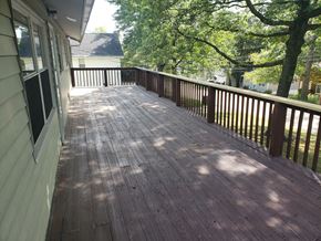 Wadsworth apartment for rent - A wooden deck with a railing and trees in the background.