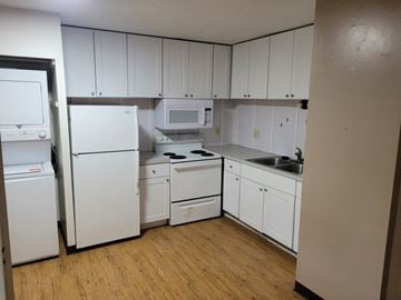 Wadsworth apartment for rent - A kitchen with white appliances and cabinets.