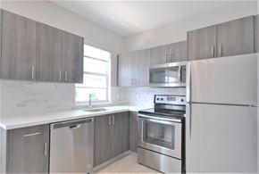 Miami Beach apartment for rent - an empty kitchen with stainless steel appliances and a window