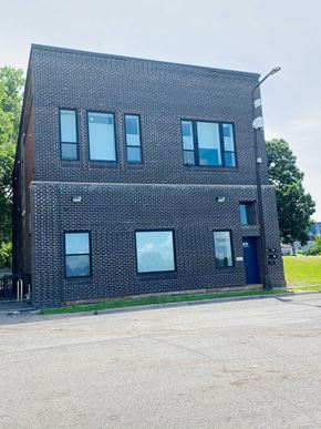 Saint Paul apartment for rent - the front of a brick building with a blue door and windows