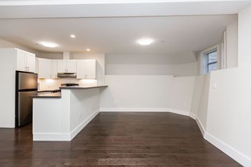 San Francisco apartment for rent - A kitchen with white cabinets and a wooden floor.
