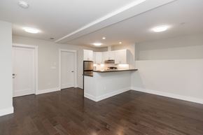 San Francisco apartment for rent - A kitchen with white cabinets and a wooden floor.