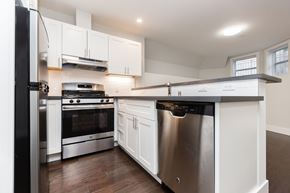 San Francisco apartment for rent - A modern kitchen with stainless steel appliances and white cabinets.