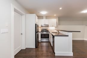 San Francisco apartment for rent - A modern kitchen with white cabinets and stainless steel appliances.