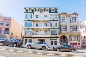 San Francisco apartment for rent - A row of three-story buildings with cars parked in front.