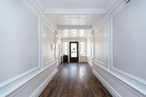 San Francisco apartment for rent - A long hallway with white walls and wood floors.