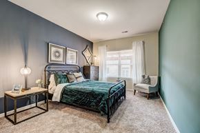 Upper St Clair apartment for rent - a bedroom with a bed and a chair and a window
