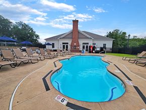 Upper St Clair apartment for rent - a pool with chairs and a building in the background