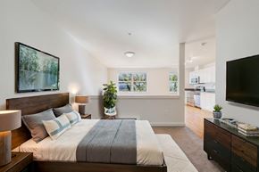Seattle apartment for rent - a bedroom with a large bed and a tv