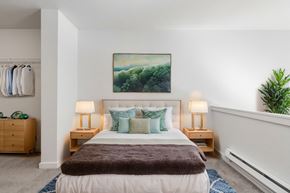 Seattle apartment for rent - a bedroom with a bed and a painting on the wall