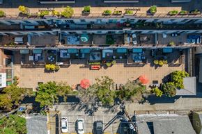 Seattle apartment for rent - an aerial view of an urban neighbourhood with cars parked on the street and trees