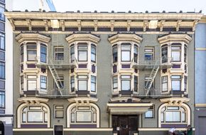San Francisco apartment for rent - the facade of a brick apartment building with fire escapes