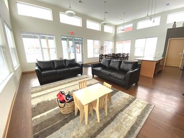 Madison apartment for rent - A living room with a black couch and a wooden table.