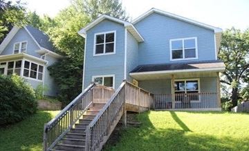 Saint Paul apartment for rent - a blue house with a porch and a wooden deck