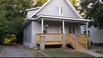 Saint Paul house for rent - A house with a grey siding and a wooden porch.