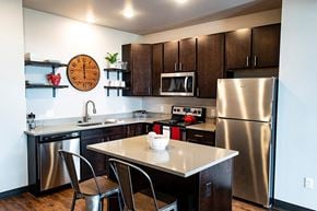 Waukee apartment for rent - a kitchen with stainless steel appliances and a counter top