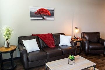 Waukee apartment for rent - a living room with a leather couch and a coffee table