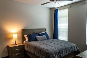 Waukee apartment for rent - a bedroom with a bed and a ceiling fan