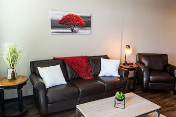 Waukee apartment for rent - a living room with a leather couch and a coffee table