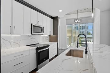 Charlotte apartment for rent - A modern kitchen with white cabinets and marble countertops.