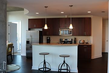 Charlotte apartment for rent - A kitchen with a white counter and brown cabinets.