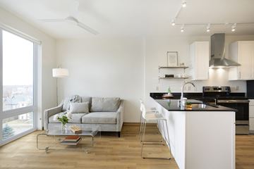 Minneapolis multi-family for rent - a living room with a couch and a kitchen