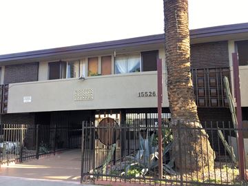 North Hills apartment for rent - a building with a tree and a fence in front of it