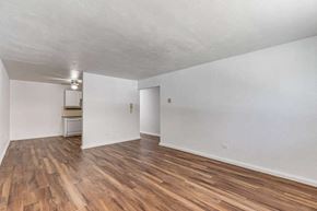 Denver apartment for rent - A room with wooden flooring and white walls.