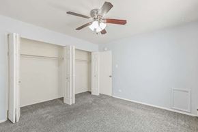 Denver apartment for rent - A room with a ceiling fan and carpeted floor.