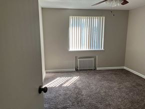 Denver apartment for rent - a room with a radiator and a window